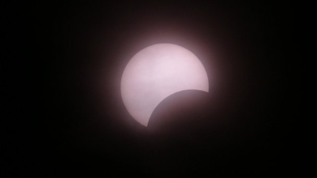 The Moon covering the Sun of partial eclipse, astronomical phenomenon. 