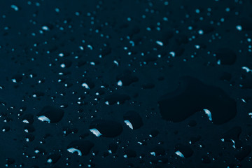 Drops of water on a color background. Blue. Shallow depth of fie