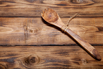 Wooden spoon on old wooden burned table or board for background