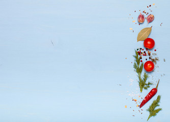 Herbs and spices on light blue wooden background. Space for text