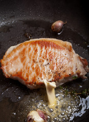 Fresh meat is fried in a frying pan with thyme and garlic. Selec