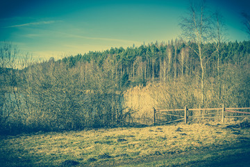 Obraz premium Vintage landscape of farm near lake.