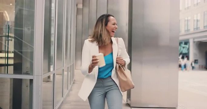 Beautiful mixed race business woman walking through city