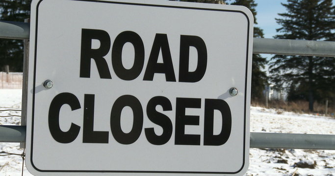 Sign indicating road closed for snow in winter in Canada
