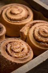 Cinnamon rolls on the wooden background