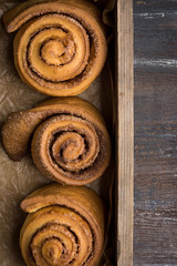 Cinnamon rolls on the wooden background