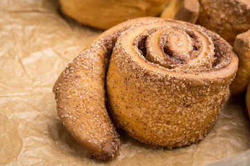 Cinnamon rolls on the wooden background