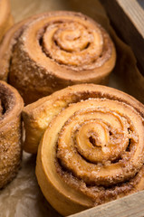 Cinnamon rolls on the wooden background