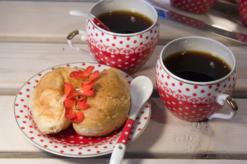 croissants and two cup of coffee on white wooden background
