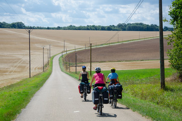Burgundy, France - CIRCA August, 2015 - Biker with panniers cycling near Noyers