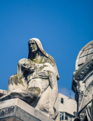 angel holding a man statue