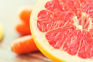 Fototapeta na wymiar close up of fresh juicy grapefruit slice on table