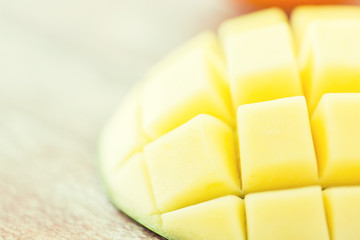 close up of ripe mango slice on table