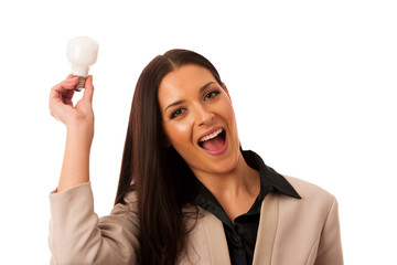 Woman holding light bulb above head as a sign of new idea.