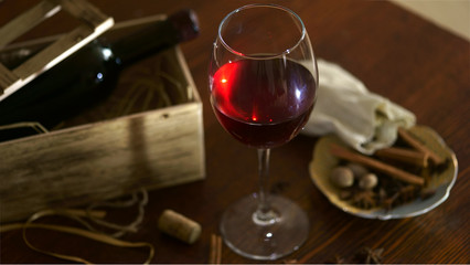 Bottle of red wine with dark glass on bottom and top reflective.