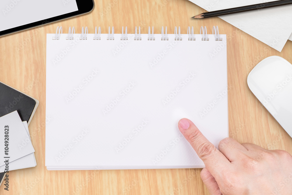 Poster hand point to blank white notebook with tablet , mouse ,pencil a