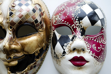 Two Venetian carnival masks on a light background

