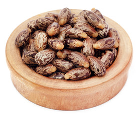 Castor beans in a wooden bowl