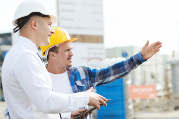 builder and architect with tablet pc outdoors