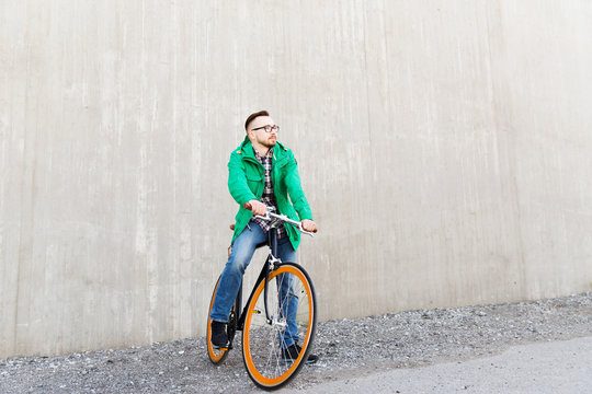 happy young hipster man with fixed gear bike