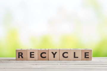 Recycle sign on a wooden table