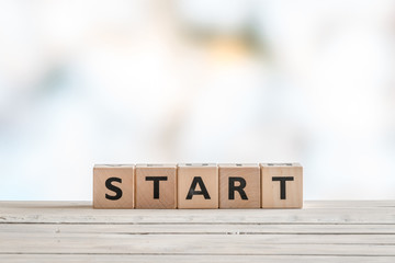 Start sign on a wooden table