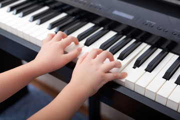 Fototapeta na wymiar Child playing on a digital piano