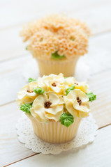 home made sponge cupcakes with flowers buttercream frosting