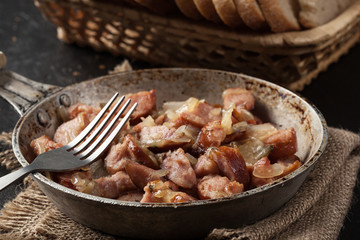 Pieces of sausage fried with onions