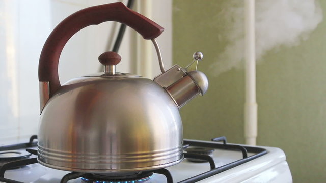 kettle boiling on a gas stove