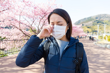 Woman suffer from allergy from pollen allergy at sakura season