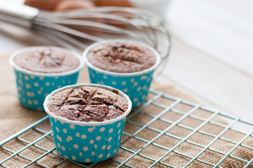 chocolate cupcake in paper container on white board