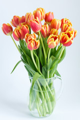 large bouquet of tulips in a glass jug