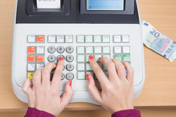 Closeup of a Cash Register with hands of woman isolated
