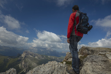 Fototapeta premium Tourist in Dolomite Mountains admiring the view