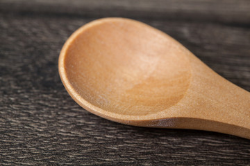 Wood empty spoon on wooden table. Kitchen utensils.