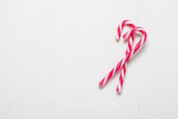 red christmas candy on white wooden background
