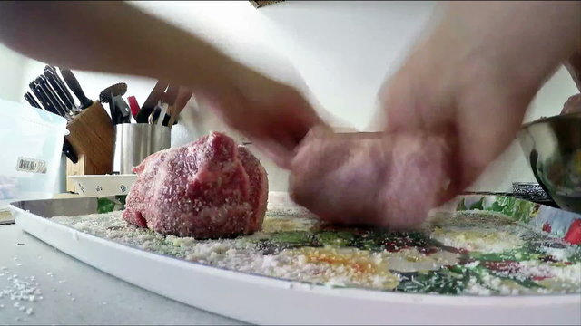 Preparing pork meat for smoking with salt and garlic