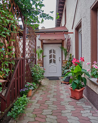 Fototapeta na wymiar house entrance with colorful flowers and plants
