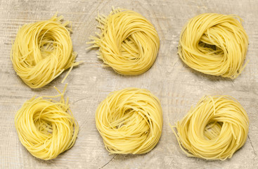Pasta lying on a wooden surface.