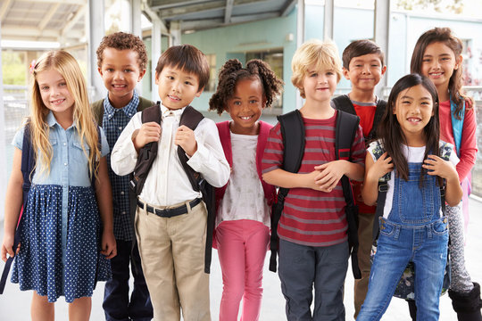 Group Portrait Of Elementary School Kids In School Corridor