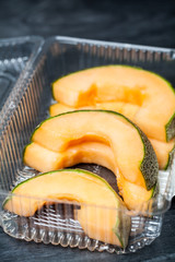 Slices Melon on black plastic box