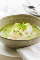 Cod served in a green sauce
