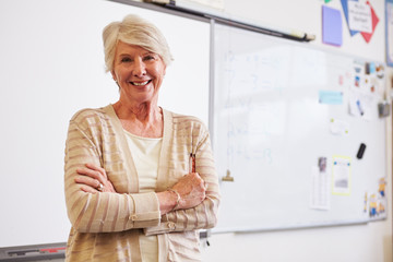 Fototapeta na wymiar Portrait of confident senior female teacher in classroom