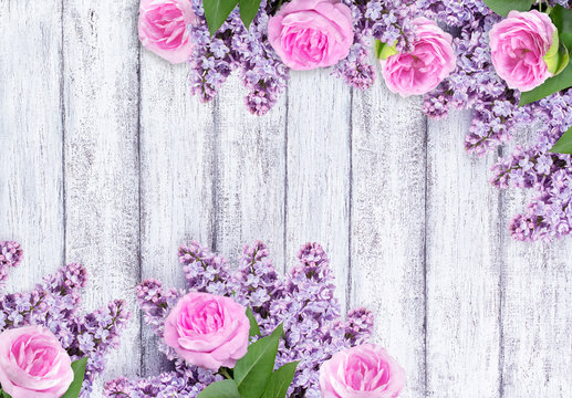 Lilac flowers with roses on background of shabby wooden planks