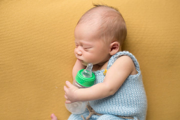 Newborn Baby Sleeping with Bottle