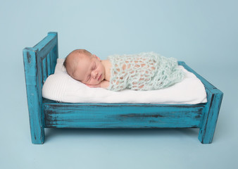 Newborn Baby Sleeping on Bed