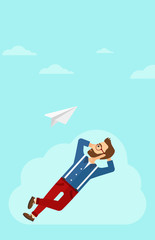 Businessman relaxing on cloud.