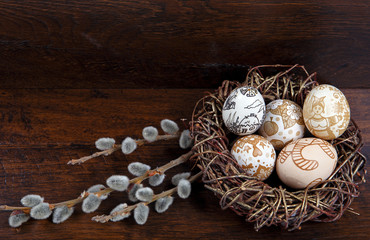  Easter eggs in a nest on a wooden background. Easter Theme. Happy Easter