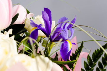 Delicate beautiful bouquet of  iris, roses and other flowers in